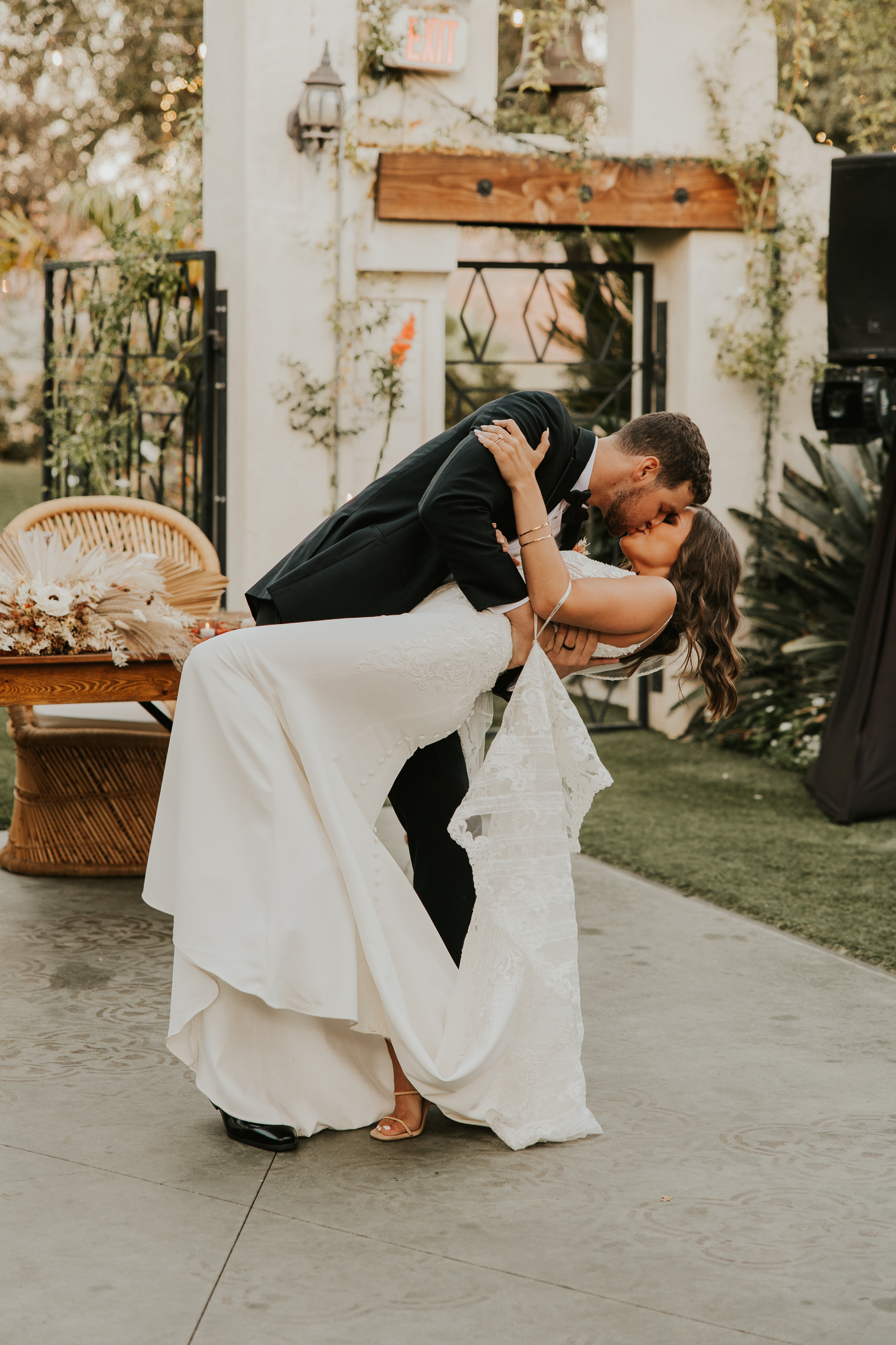 Bride wearing Bracken crepe wedding dress by Sottero and Midgley kissing her husband.