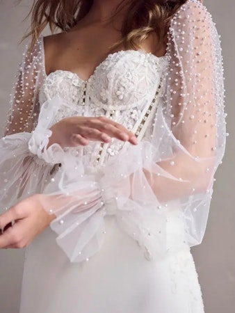 Bride wearing Doritte long sleeve wedding dress.