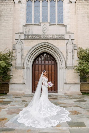 Bride wearing long sleeve Tuscany Royale wedding dress by Maggie Sottero.