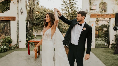 Bride wearing Bracken simple wedding dress by Sottero and Midgley being twirled by her husband.