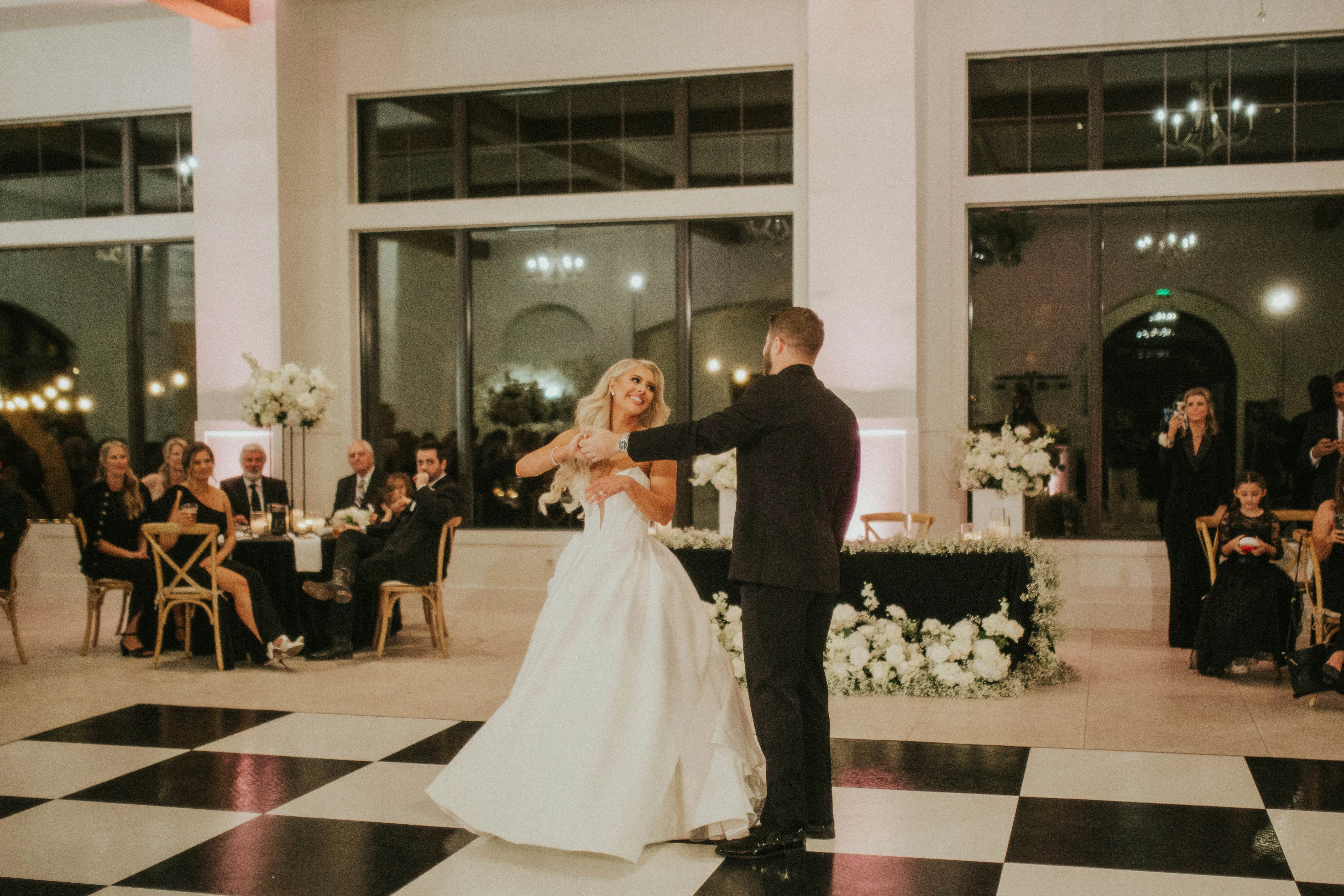 Bride wearing Derrick vintage wedding dress by Maggie Sottero and dancing with her husband.