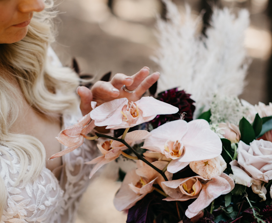 Bride wearing Maggie Sottero wedding dress holding flowers