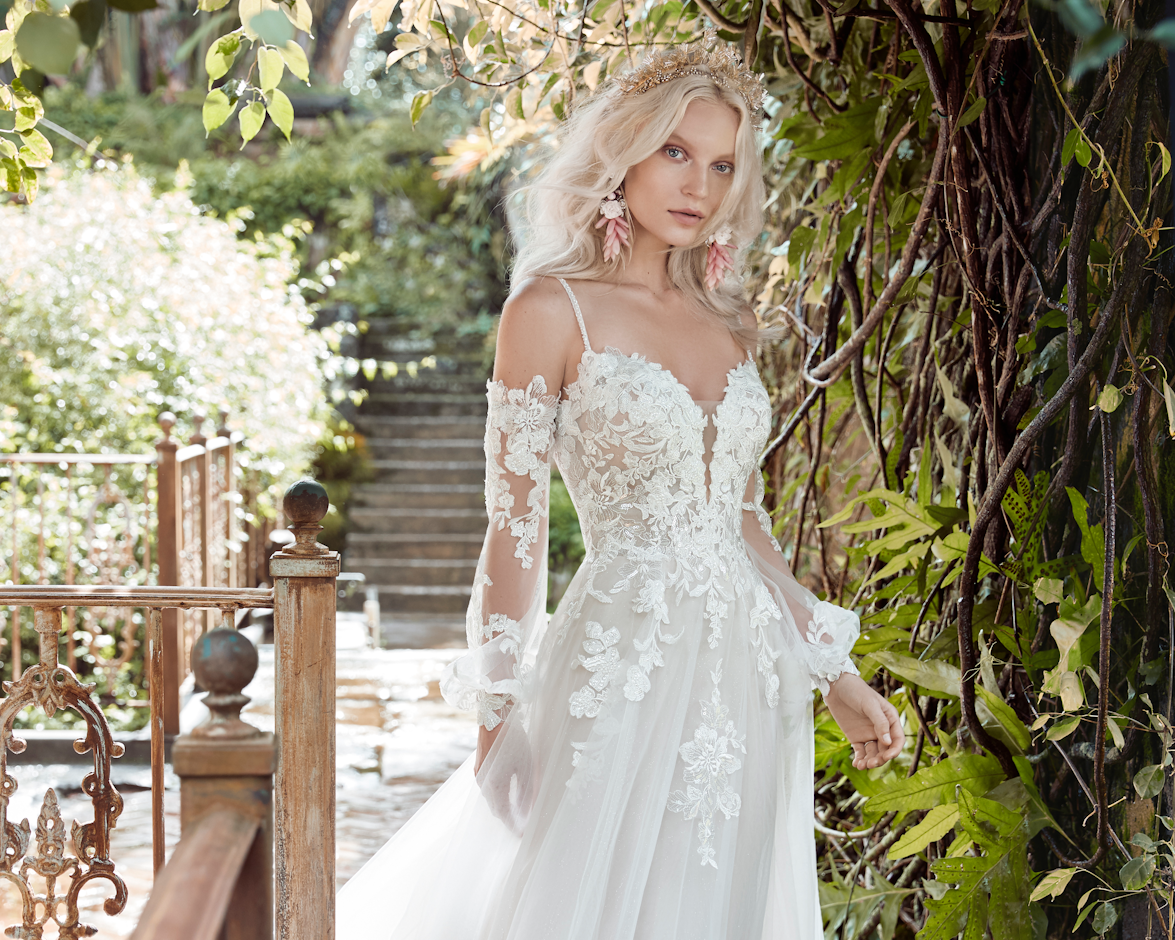 Model wearing Stevie Off-The-Shoulder A-Line Wedding Dress by Maggie Sottero